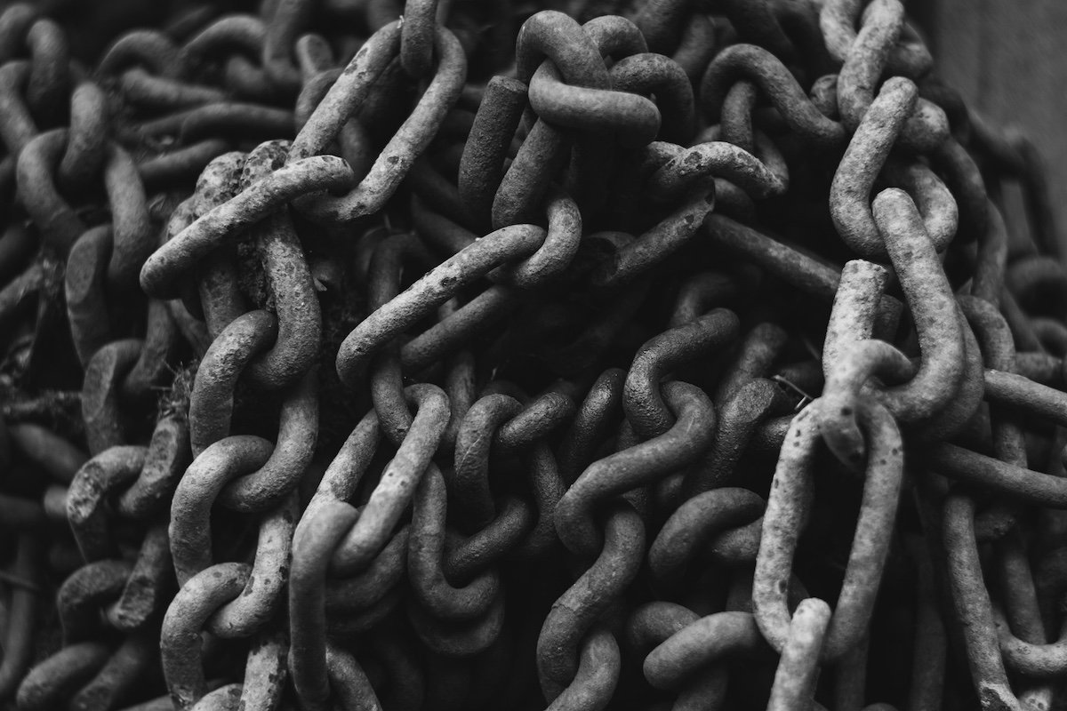 a tangled pile of rusty chains, photo in black and white